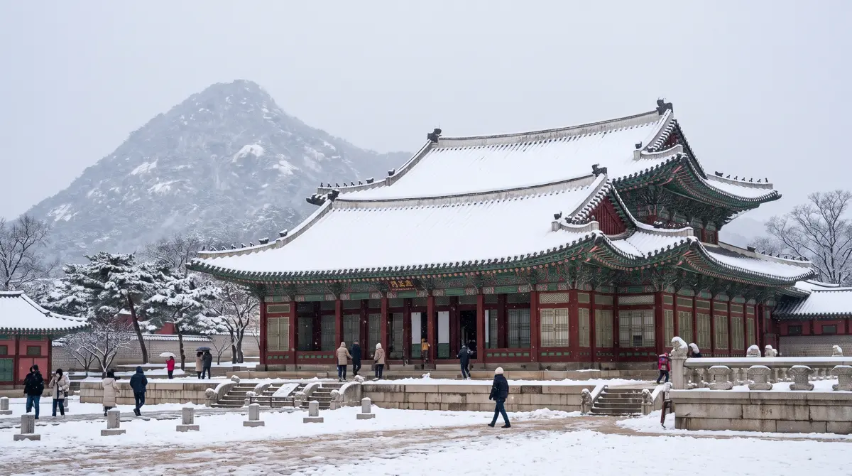 Snow in Korea: fresh snow on Gyeongbokgung Palace roofs in Seoul with Bugaksan mountain behind